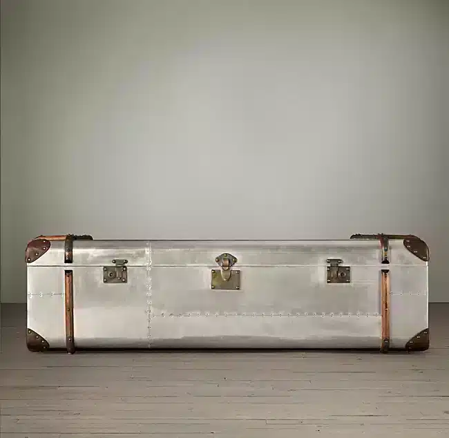 The aviator trunk coffee table is inspired by a worn, custom-made steamer trunk.